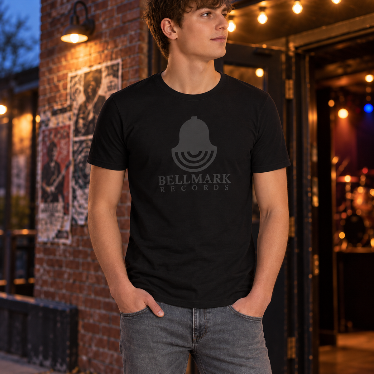 Man wearing the black Bellmark Records t-shirt with tonal bell logo