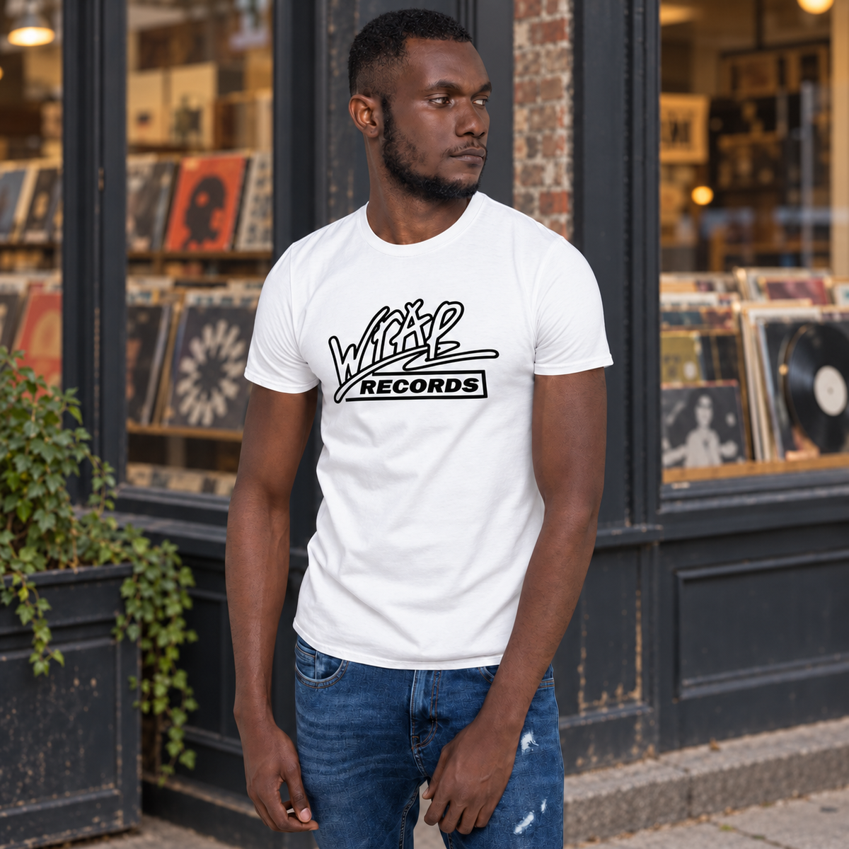 Man wearing the white Wrap Records t-shirt outside a record store